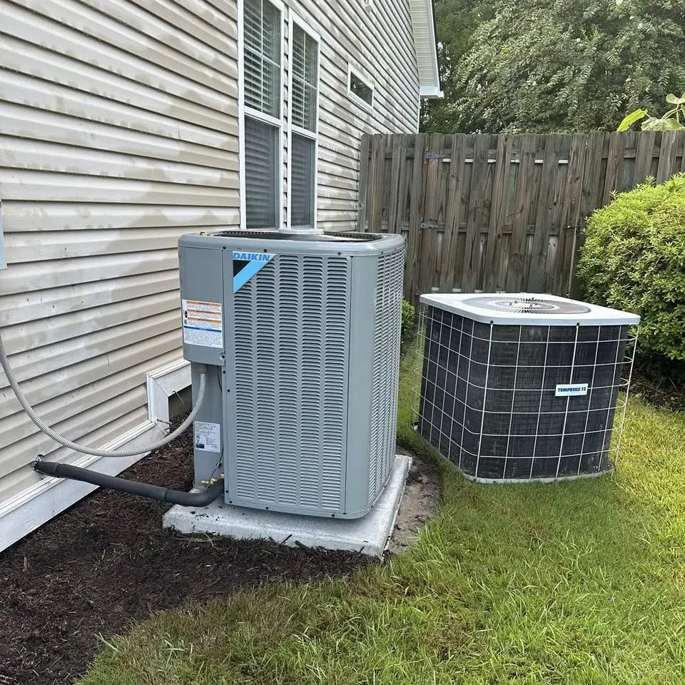 New AC condenser installed beside a home